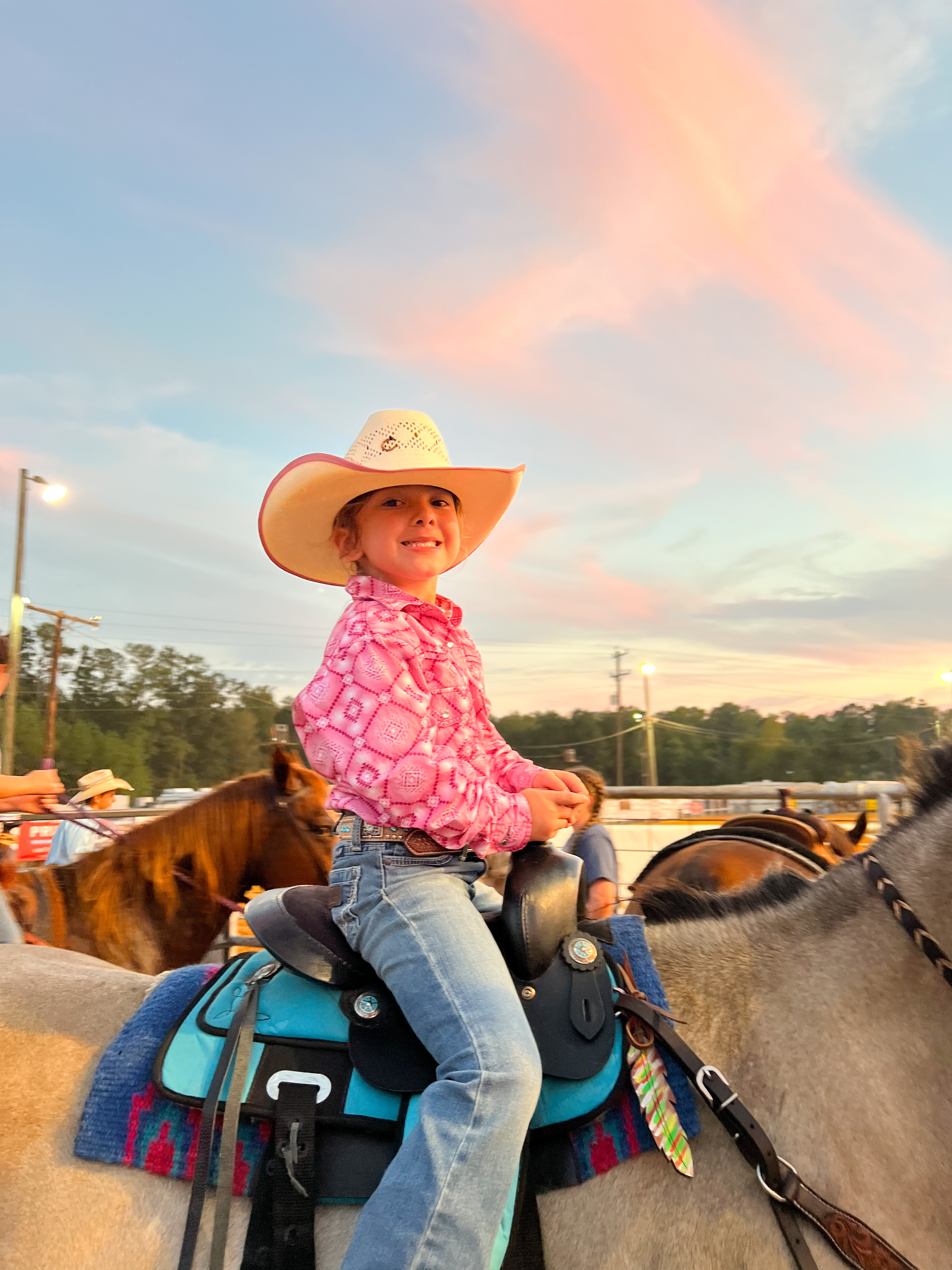 Young girl on horse at rodeo 